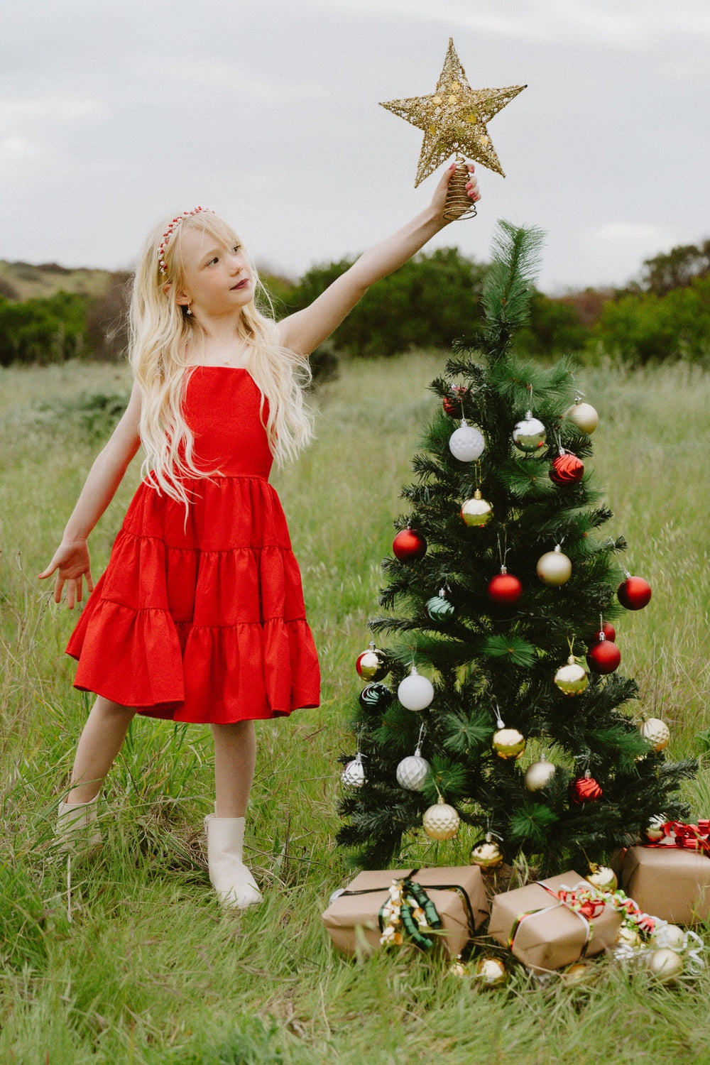Front view of red girls Christmas dress with tiered skirt and tie-up back