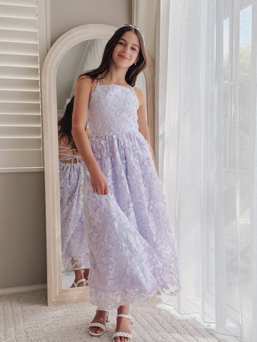 Clarissa lilac 3D flower girl dress, full-length view beside an arched mirror.