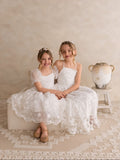 Romantic white flower girl gown with intricate 3D flower embellishments