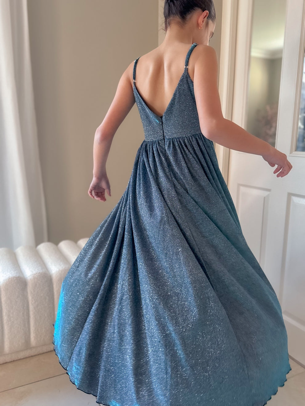 Claudia blue-green girls formal dress, flared skirt in motion from the back.