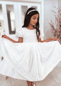 White flower girl dress with subtle shimmer and large bow