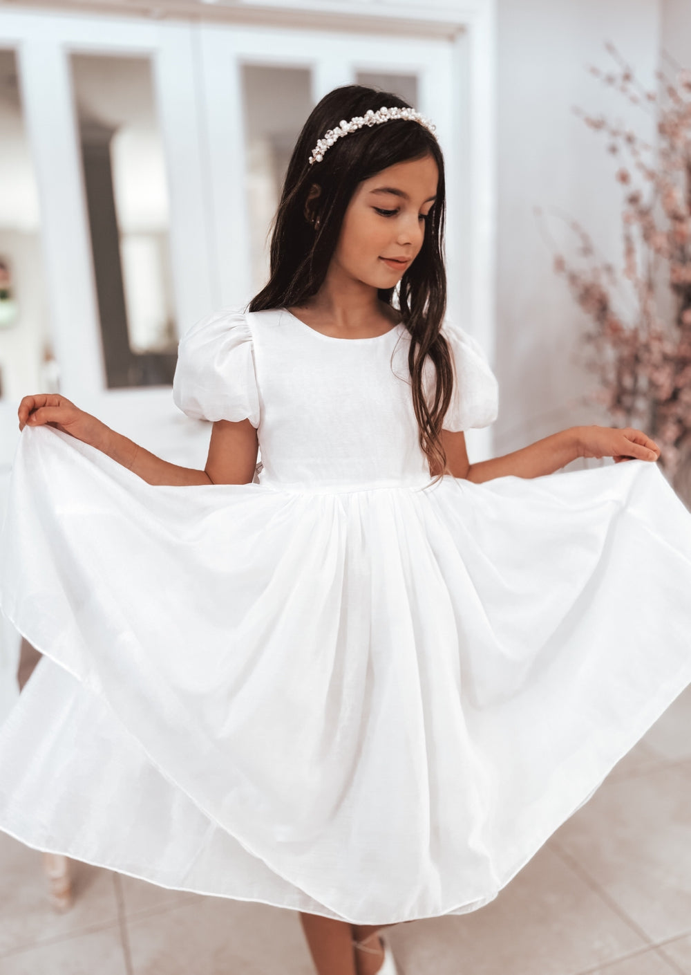 White flower girl dress with subtle shimmer and large bow