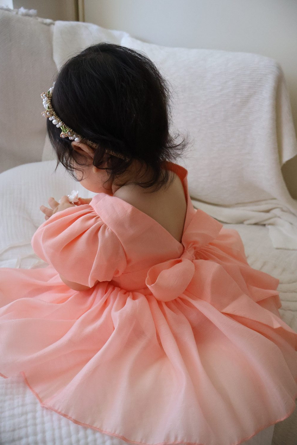 Delia Peach Baby DressPeach baby flower girl dress with soft shimmer fabric