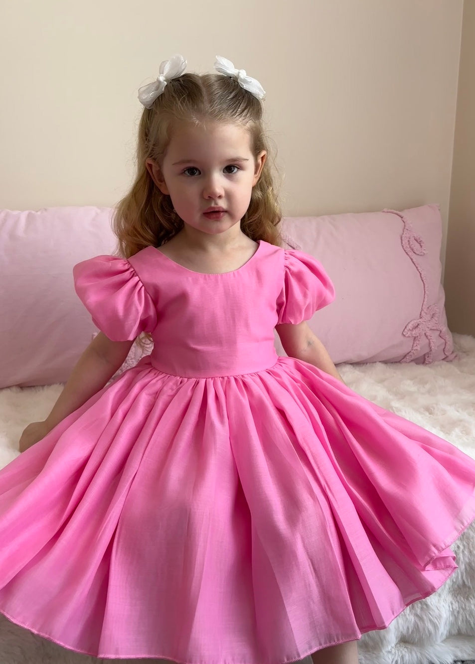 Girls vibrant hot pink special occasion dress with soft sheen fabric and bow detail