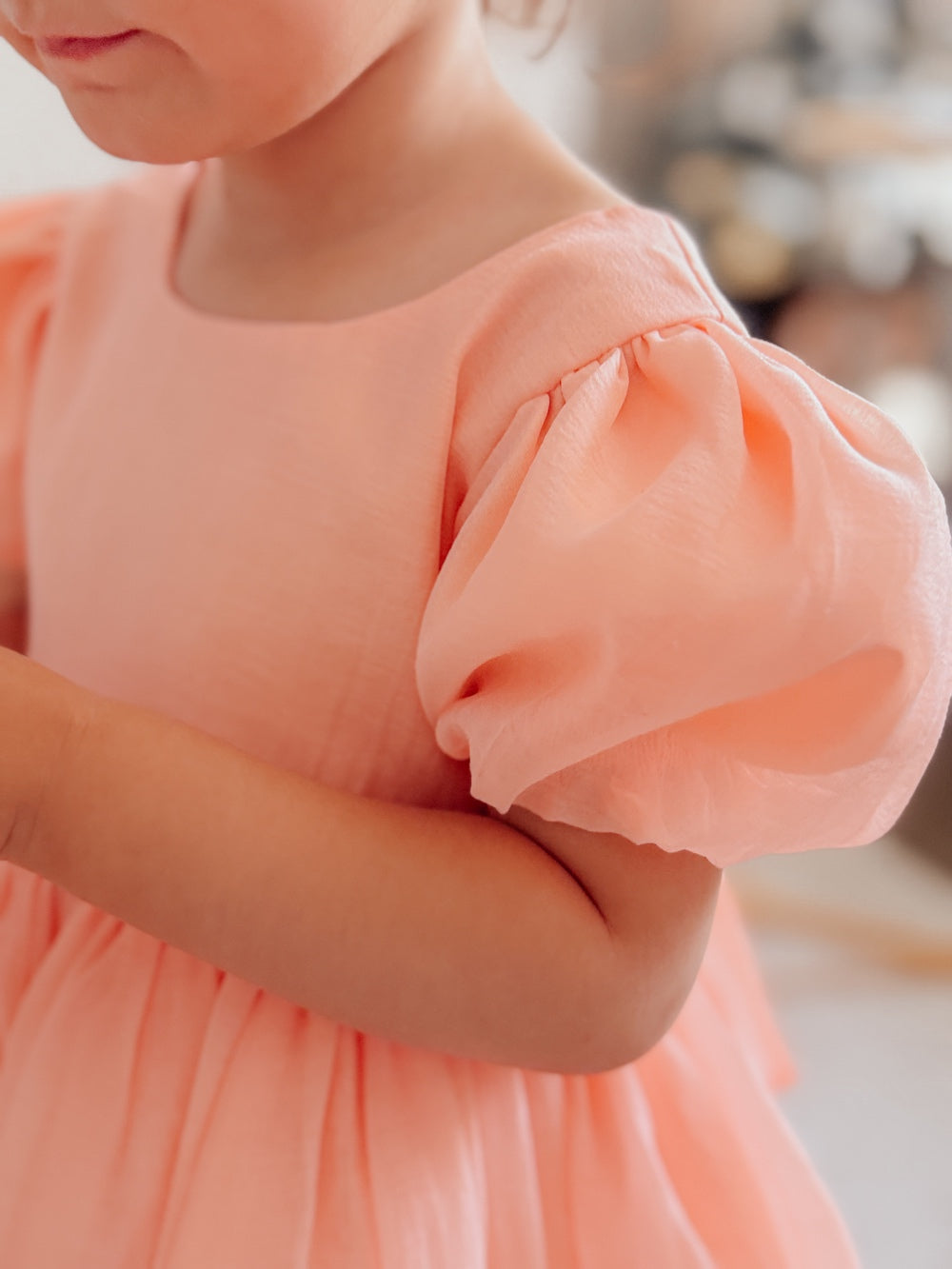 Peach birthday girls dress with classic silhouette and elegant details.
