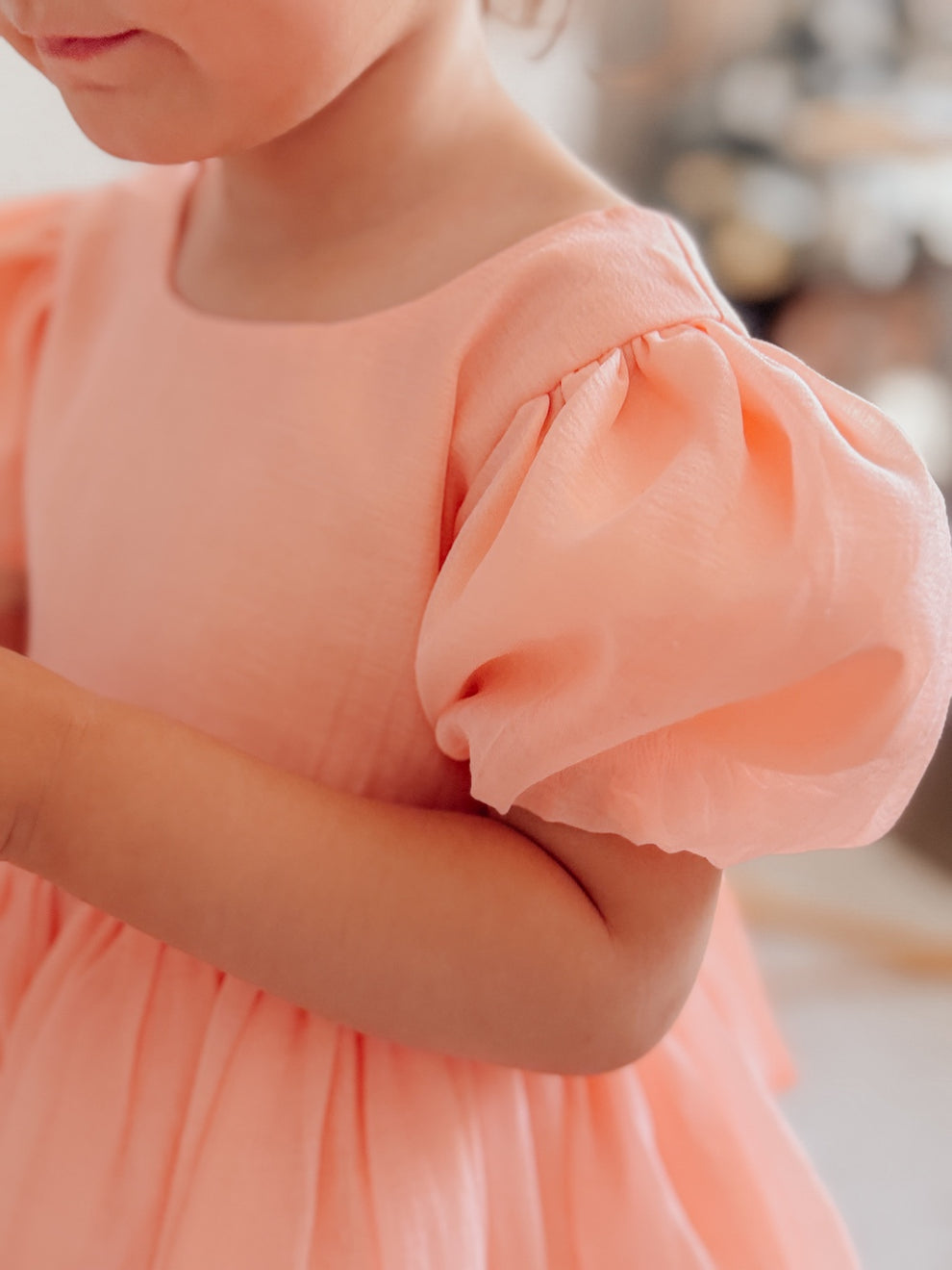 Peach birthday girls dress with classic silhouette and elegant details.