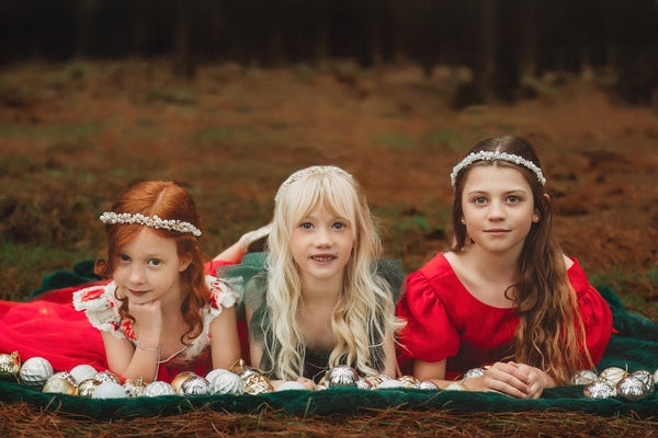 3 girls wearing Christmas oufit and pretty headbands in a family Christmas photo