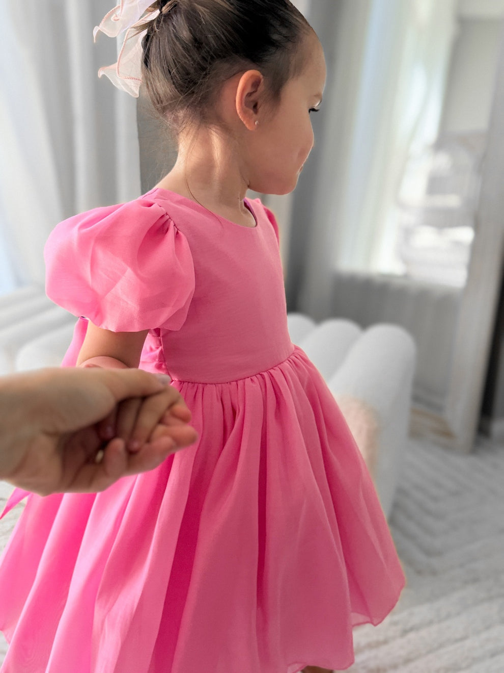 Little girl in bright pink dress posing for photoshoot – Delia Hot Pink