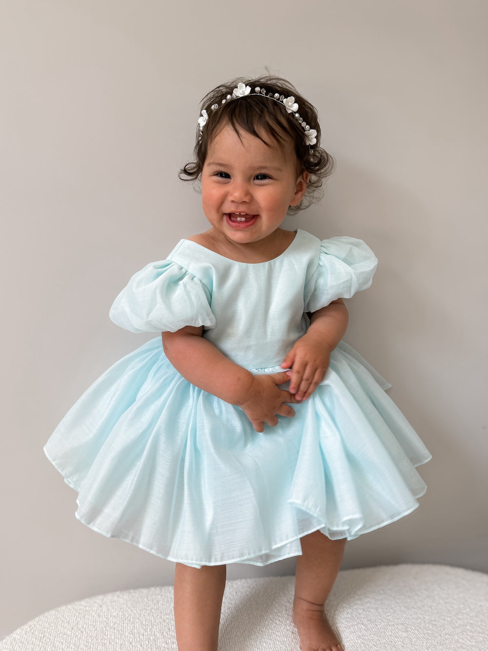 Delia Pale Blue Baby Dress with puff sleeves and V-back bow