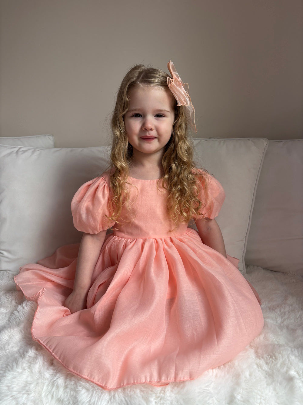 Peach girls party dress with tulle bow and classic V-back — Delia style for weddings and celebrations