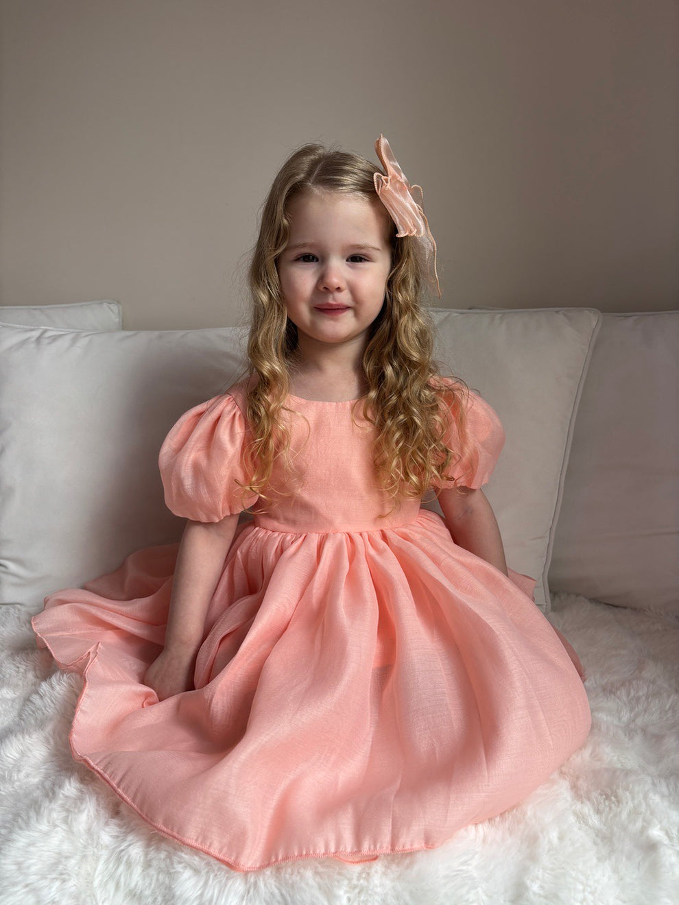 Peach girls party dress with tulle bow and classic V-back — Delia style for weddings and celebrations