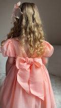 Little girl wearing Delia Peach Dress below the knee — perfect flower girl and birthday dress