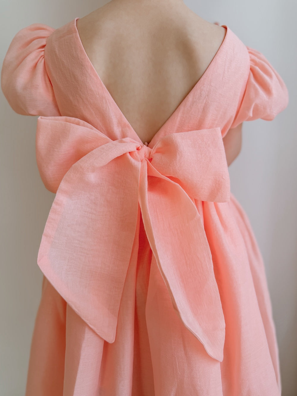 Delia Girls Peach Dress with puff sleeves and bow back