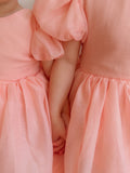 Girls peach knee-length dress with puff sleeves