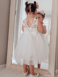 Sleeveless girls white communion dress with classic tea length skirt