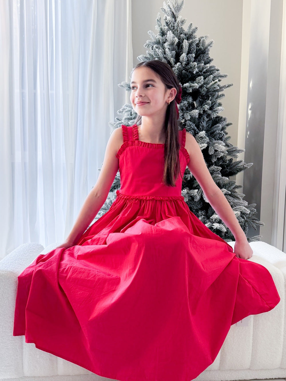 Eden Girls Midi Christmas Dress - Christmas Dresses and RompersSeated girl in red Christmas dress with midi skirt draped softly
