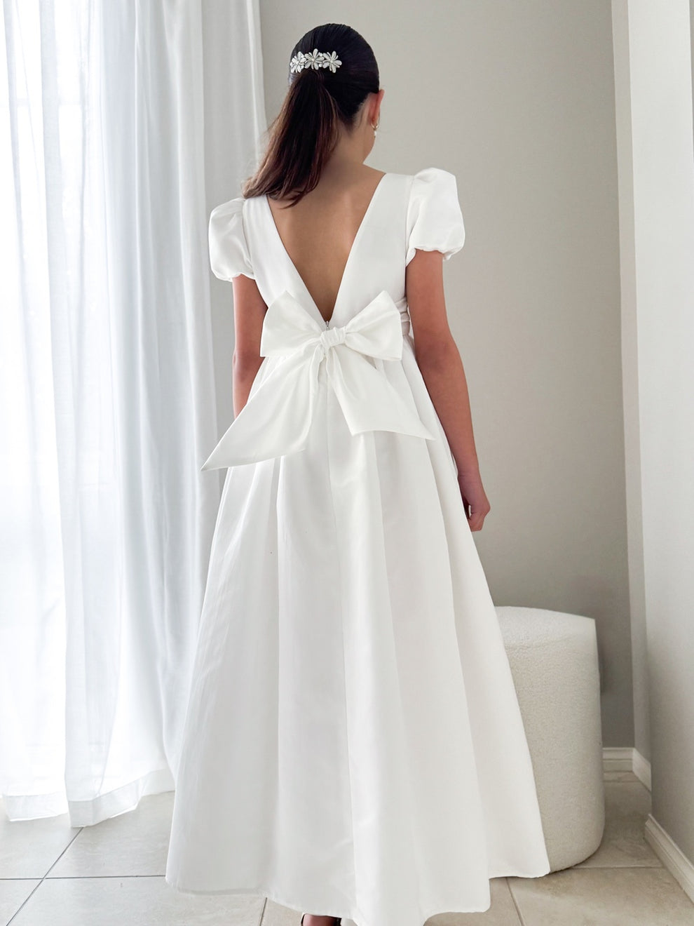 Model standing in the Elise Dress to showcase movement and elegant length