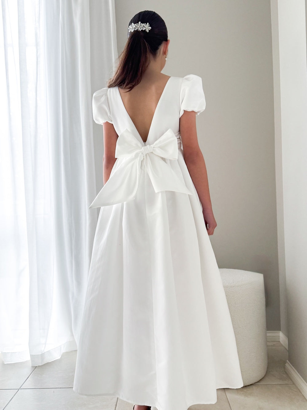 Elise Girls Full Length White Satin Dress - Communion DressesModel standing in the Elise Dress to showcase movement and elegant length
