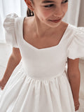Close-up of sweetheart neckline and satin bodice with delicate puffed sleeves