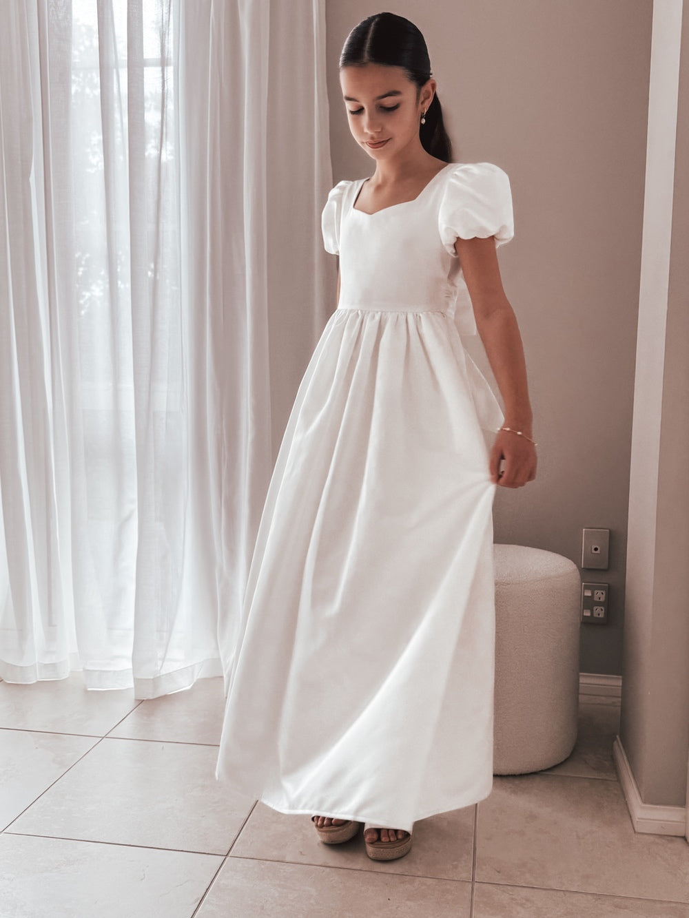 Full front view of Elise Girls Full Length White Satin Dress with puff sleeves and flowing satin skirt