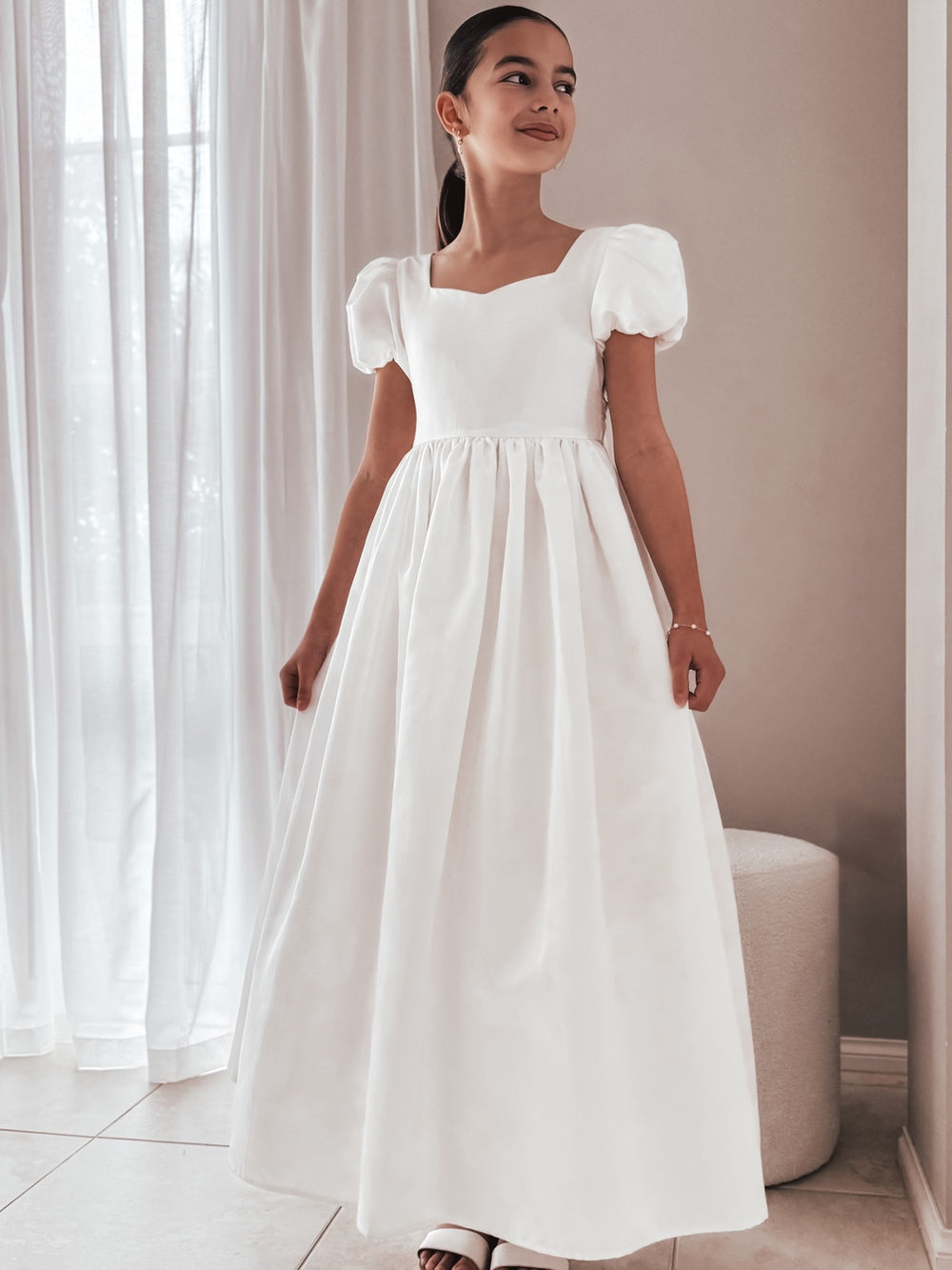 Front profile of the dress displaying full-length satin skirt and soft shine