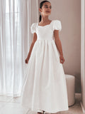 Front profile of the dress displaying full-length satin skirt and soft shine