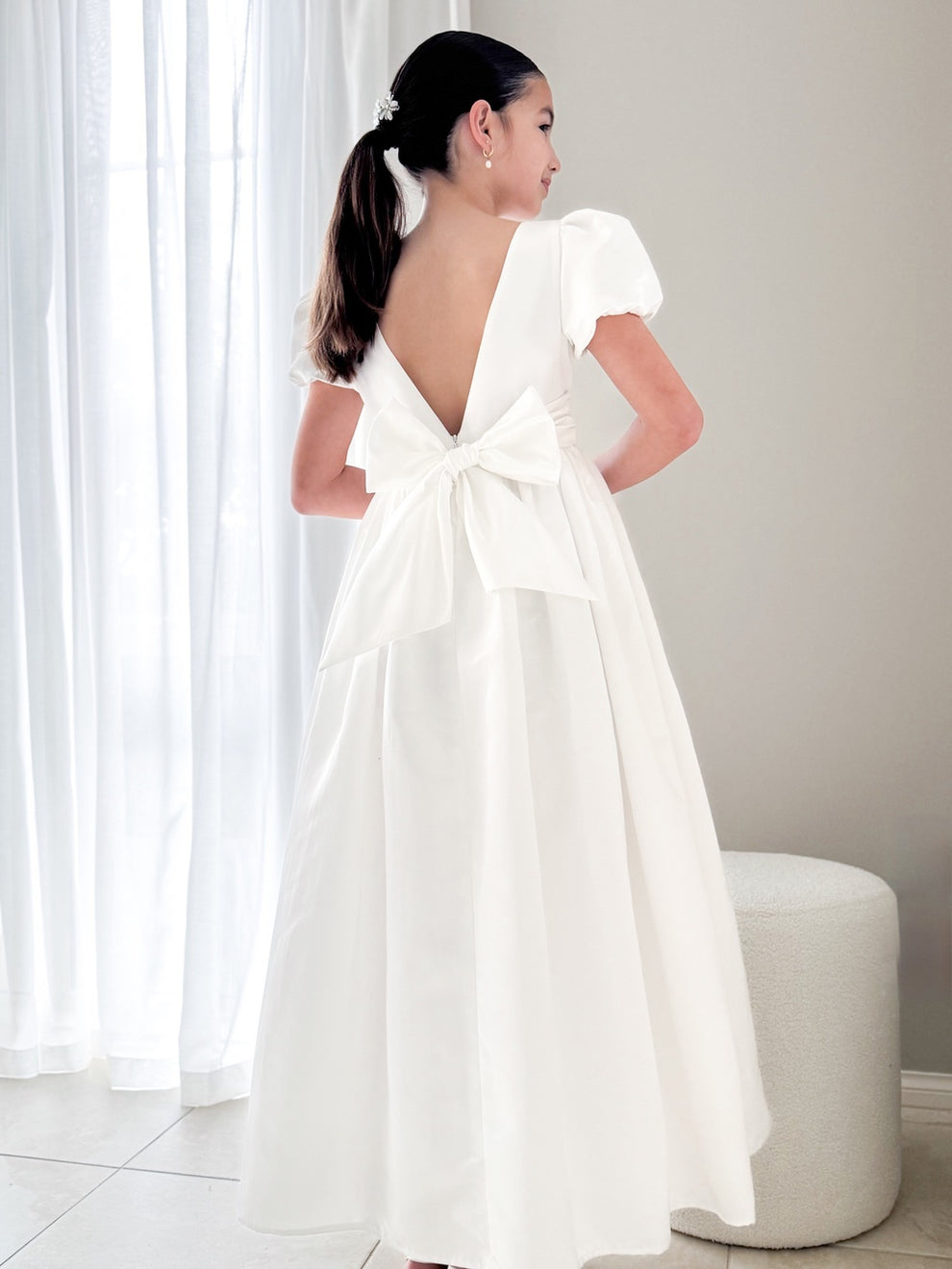 Back view showing v-back and elegant satin bow detail