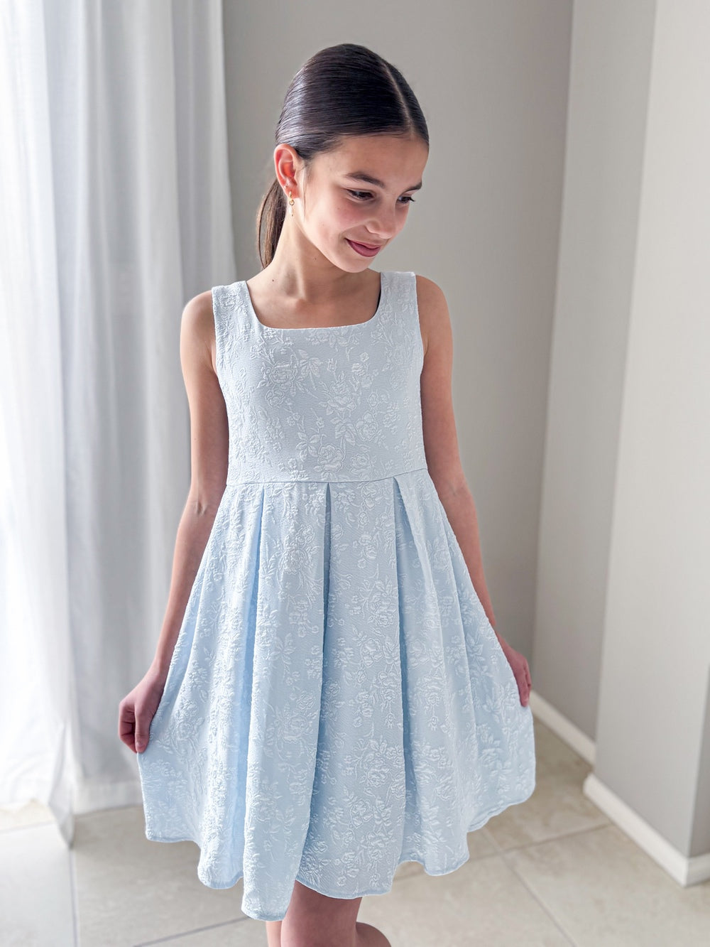Emilee Light Blue Girls Graduation DressGirl wearing Emilee light blue graduation dress standing front-facing
