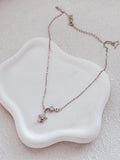 Close-up of Estelle girls necklace on jewellery dish.