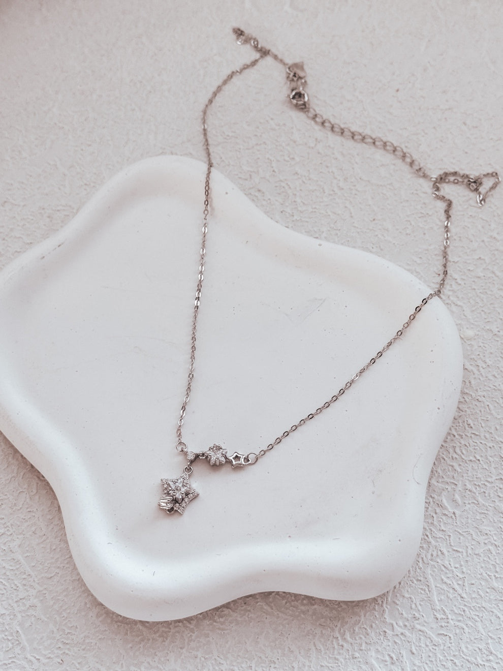 Close-up of Estelle girls necklace on jewellery dish.