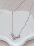 Close-up of Eternal Bloom girls necklace on white background