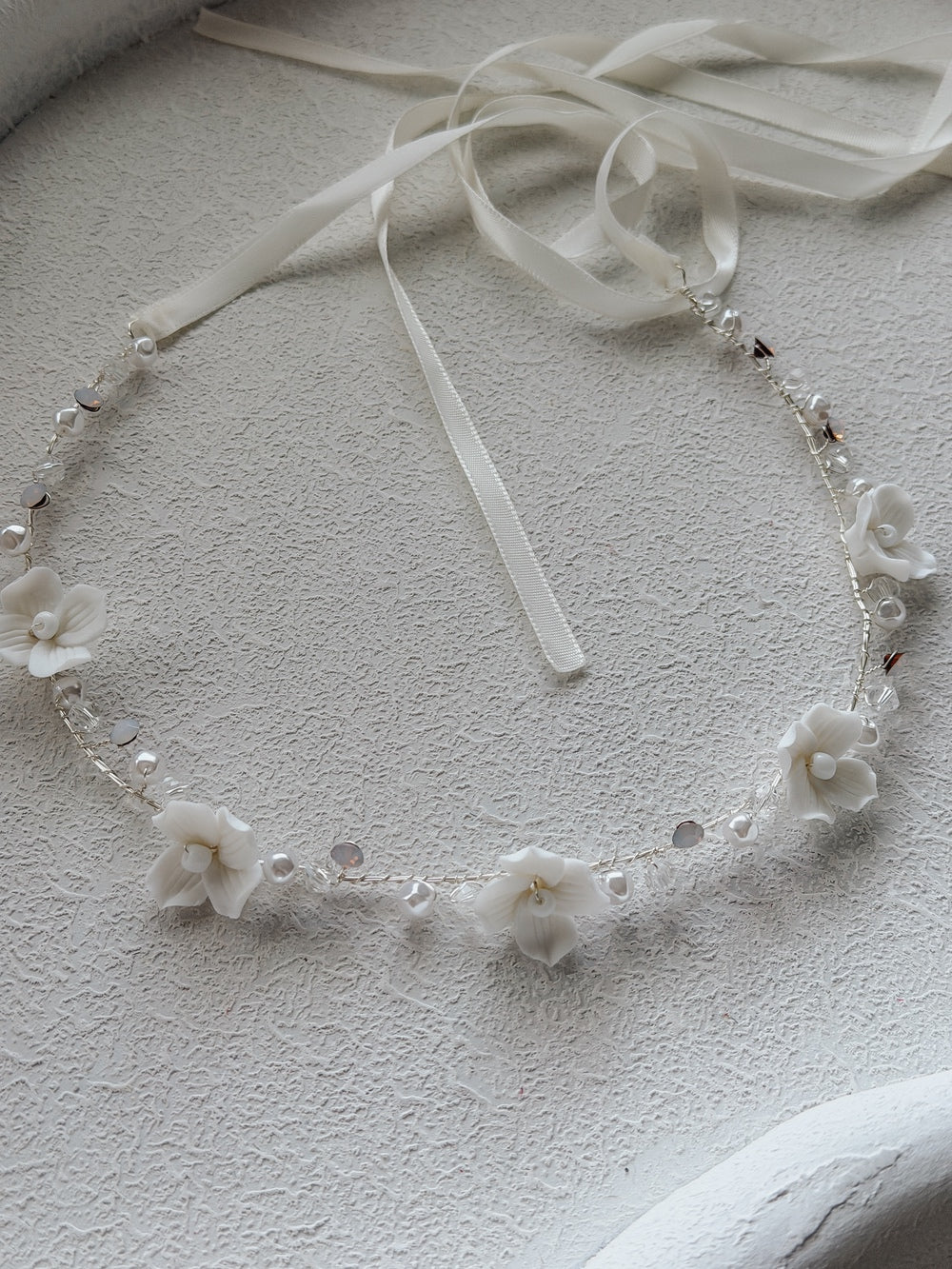 Ever After Girls Silver Headpiece flat lay – porcelain flowers, crystal beads, and silver wire design
