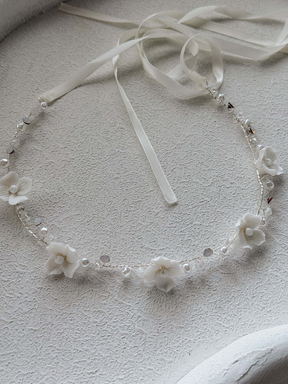 Ever After Girls Silver Headpiece flat lay – porcelain flowers, crystal beads, and silver wire design