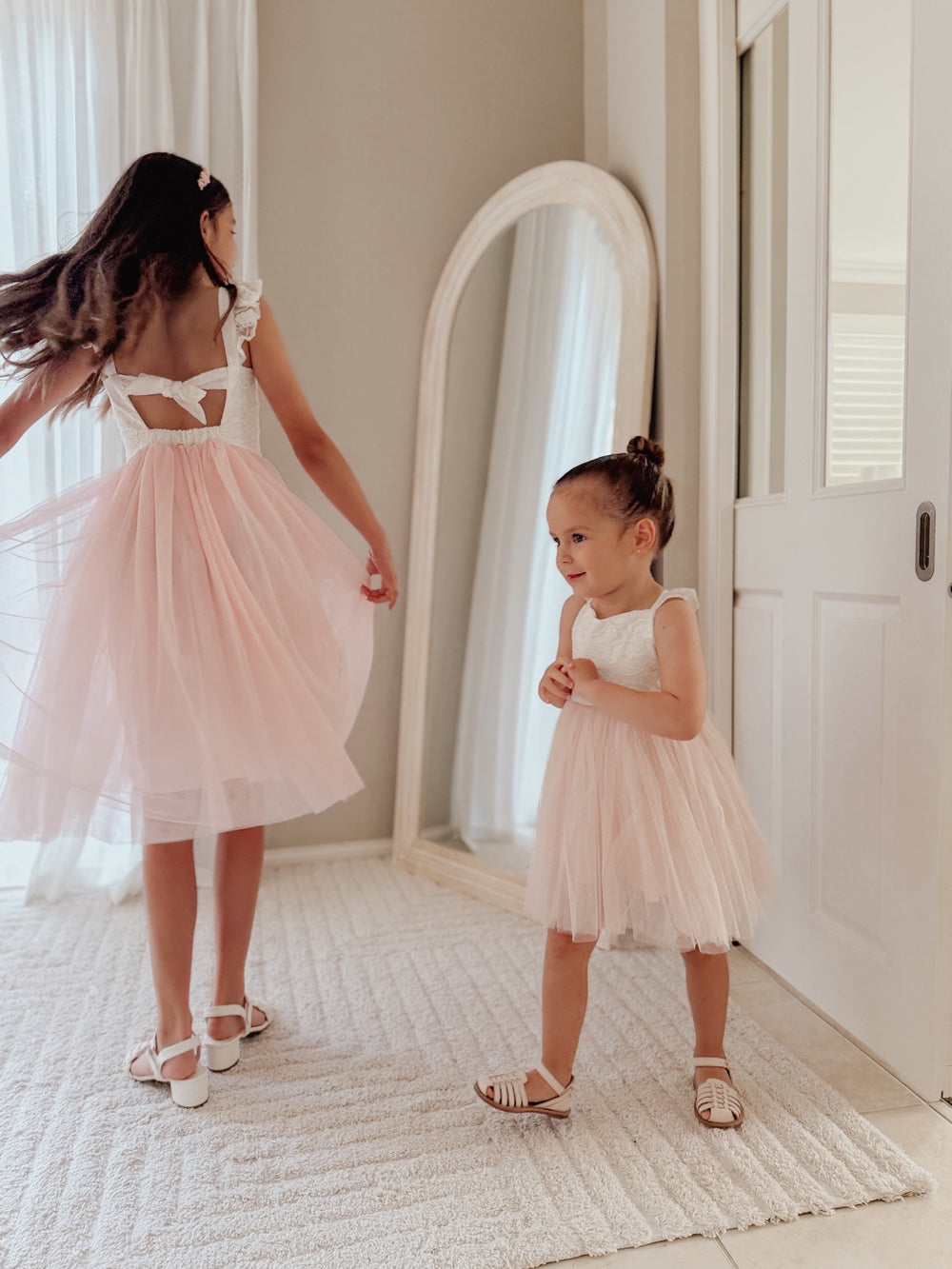 Soft pink flower girl dress with tie up lace back