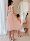 Pink girls occasion dress with ruffle shoulders and tie back