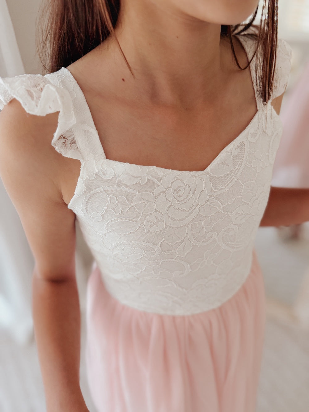 Lace bodice detail on soft pink girls birthday dress