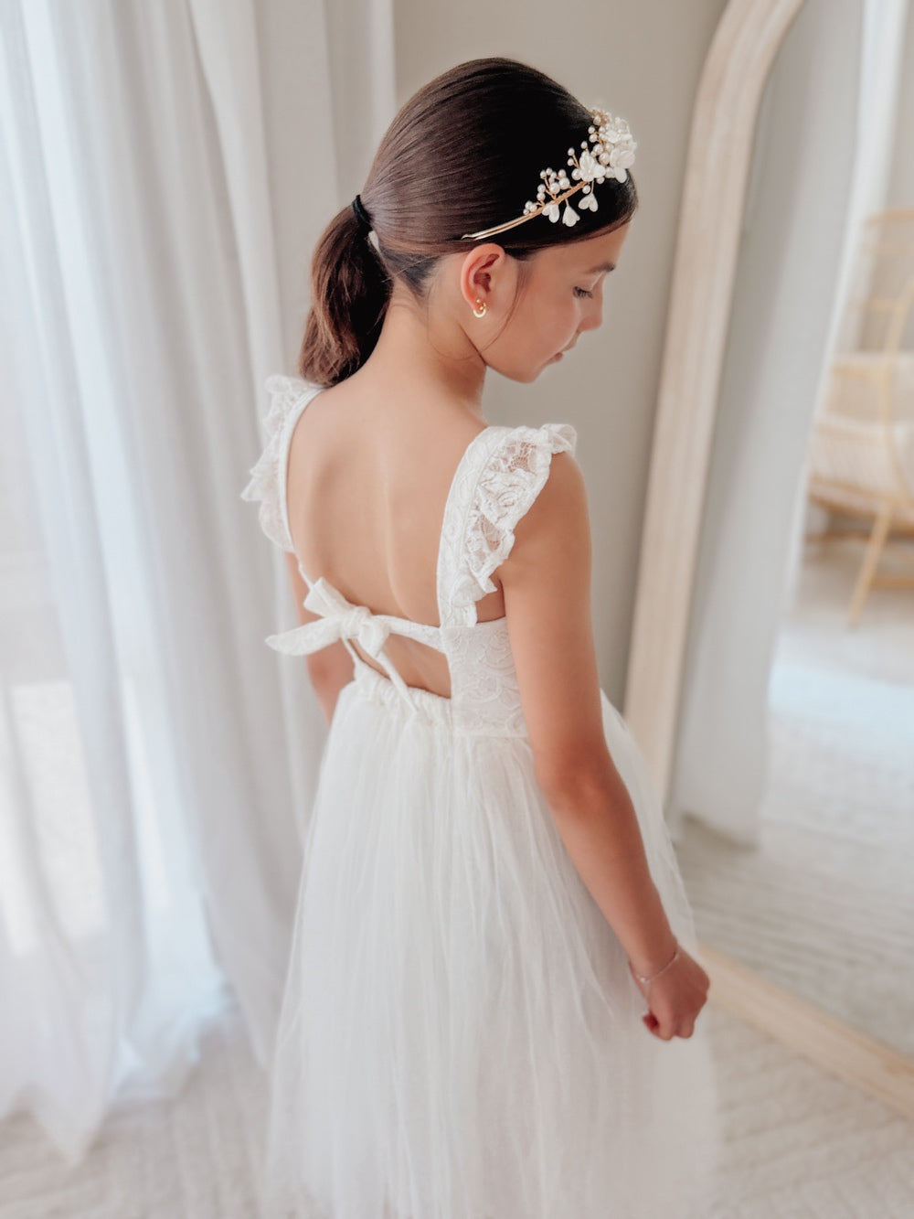 White lace flower girl dress with ruffle shoulders and tie back