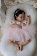 Baby girl first birthday romper with floral bodice and soft pink tulle skirt