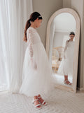 Elegant flower girl dress in soft white lace with long sleeves