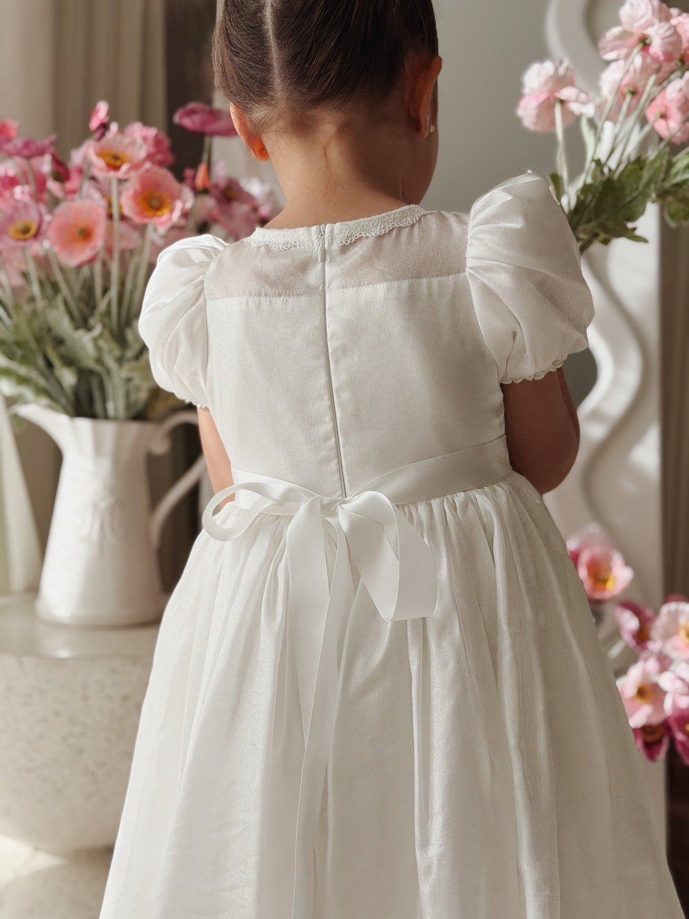 White christening dress with puff sleeves and bow