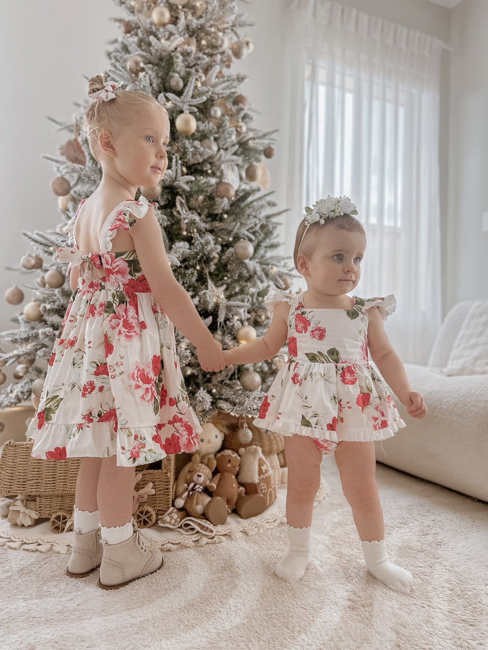 Faith Baby Girls Christmas Romper displayed with matching Faith Girls Floral Dress for coordinated sibling outfits