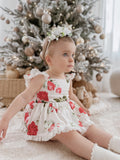 Baby wearing Faith Floral Christmas Romper playing under twinkling Christmas lights