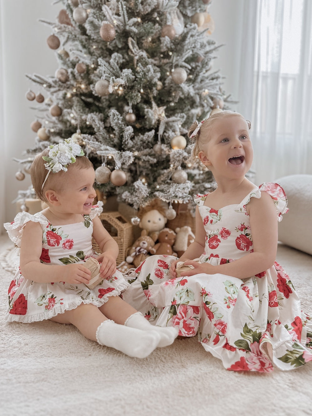 Detail shot of floral print fabric – red and green Christmas flowers on white cotton background
