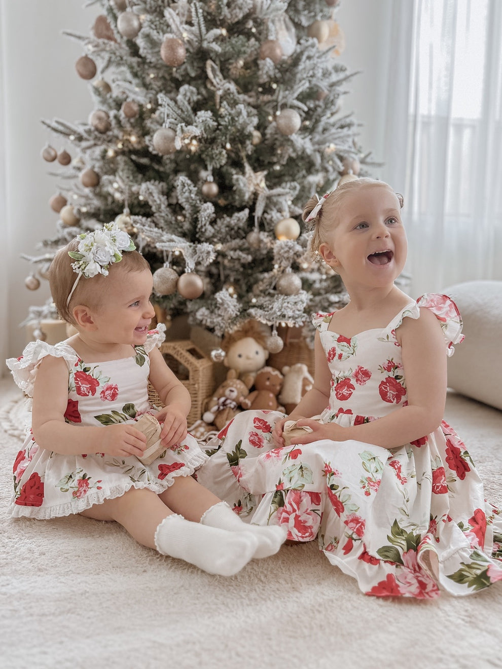 Detail shot of floral print fabric – red and green Christmas flowers on white cotton background