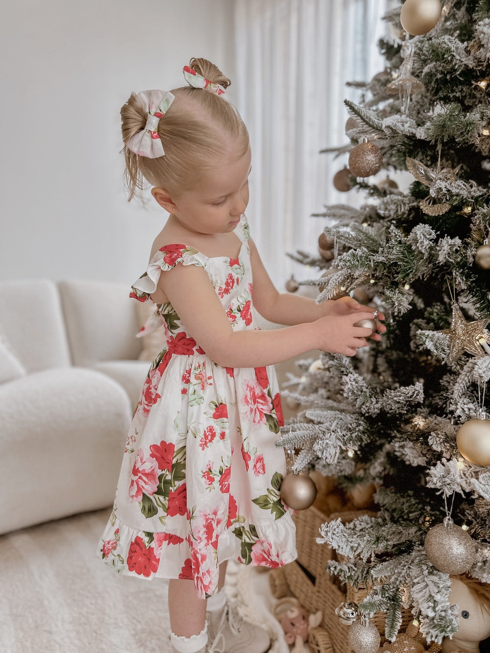 Faith Girls Christmas Rose Dress displayed with Christmas accessories and matching bows
