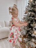 Faith Girls Christmas Rose Dress displayed with Christmas accessories and matching bows