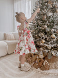 Side view of Faith Christmas Rose Dress showing flowing skirt and floral print
