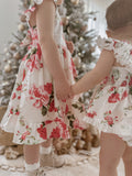 Detail shot of floral print fabric – red and green Christmas flowers on white cotton background
