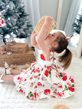 Toddler in Faith Christmas Dress hugging her big sister during Christmas photoshoot
