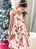 Two sisters wearing Faith Christmas Rose Dresses for Christmas Day celebration
